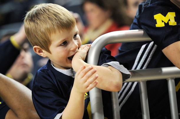 Five-year-old Kenyon Bushinski, of Jackson, waits for the team to take the court at Crisler Center on Tuesday. Melanie Maxwell I AnnArbor.com